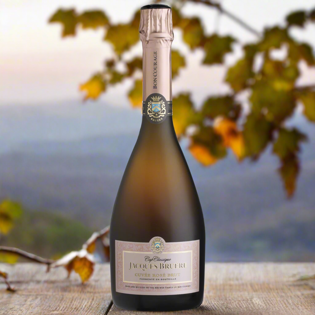 Jacques Bruere Cap Classique Cuvée Rosé with vineyard backdrop at sunset