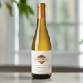 Bottle of Kendall-Jackson Chardonnay on a clean white surface with soft natural light and subtle reflections. Blurred green foliage in the background. Simple, fresh, and elegant.
