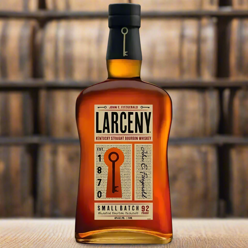Bottle of Larceny Kentucky Straight Bourbon on oak barrel in rustic rickhouse