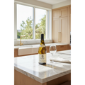 M. Chapoutier Condrieu Invitare 2022 wine bottle displayed on a polished stone kitchen island in a bright contemporary home.