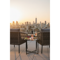 One4One Sparkling Rosé 200ml mini bottle displayed on a rooftop terrace at sunset with sparkling wine and fresh berries.