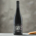 Parlez Vous Malbec bottle on modern dining table with cheese and bread
