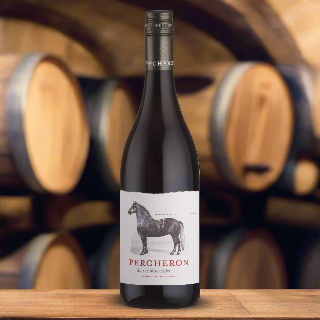 Place a bottle of Percheron Shiraz & Mourvèdre on a rustic barrel in a dimly lit wine cellar, surrounded by oak casks and a warm, earthy atmosphere.