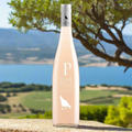 Bottle of Picpoul Rose wine with a scenic background