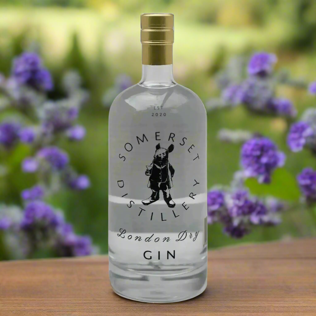 “Bottle of Somerset Distillery London Dry Gin on a rustic wooden table with juniper, apple slices, and wildflowers. Soft countryside lighting, English orchard backdrop.”