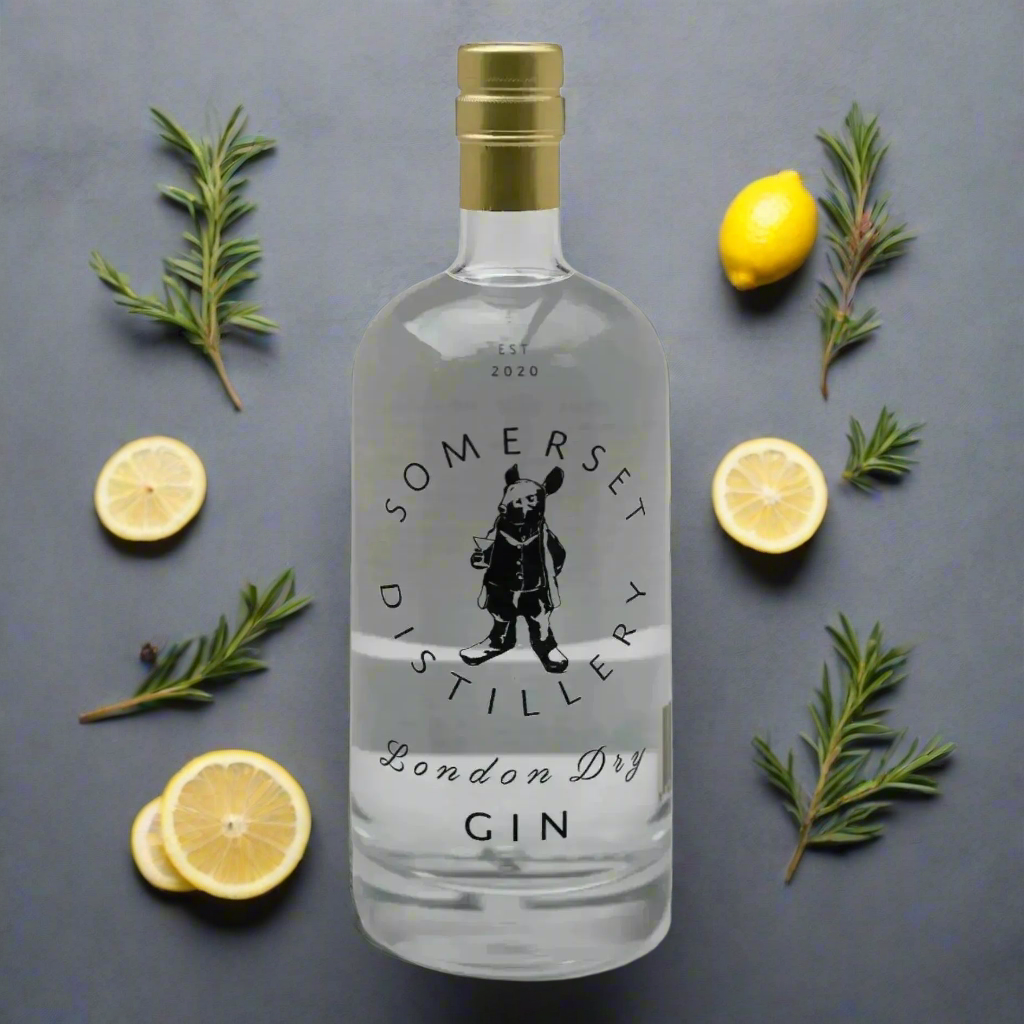 “Somerset Distillery London Dry Gin bottle on a matte slate surface with botanicals, pine sprigs, and lemon peel. Clean, minimal background with fresh, modern lighting.”
