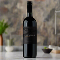 Tinamou Carmenere bottle on kitchen counter with herbs and soft natural light