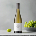 Whale Point Sauvignon Blanc with green grapes and mint on pale oak kitchen counter