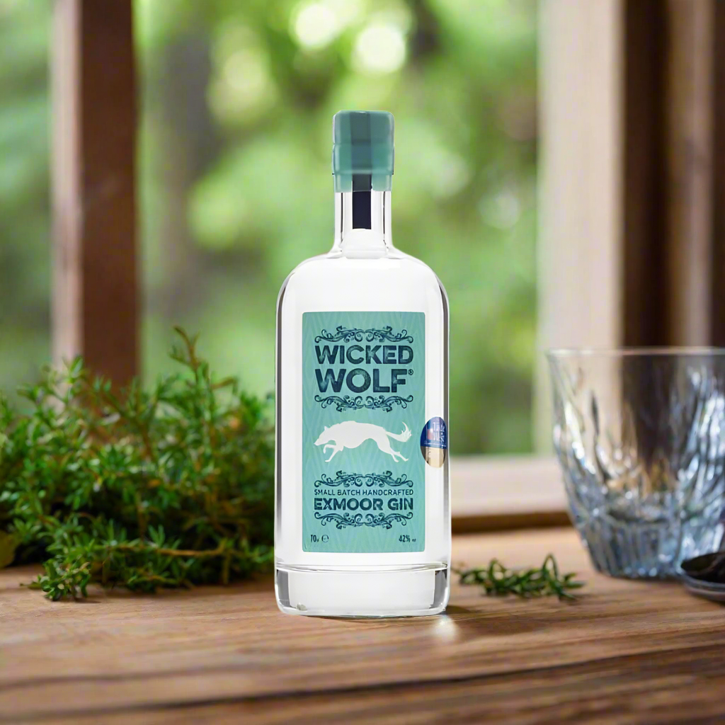 Botanical Workbench in a Woodland Cabin
A rustic tabletop with scattered juniper berries, citrus peels, and herbs. The bottle of Wicked Wolf Gin stands beside a mixing glass and a sprig of rosemary, bathed in soft natural light filtering through a woodland window—highlighting the handcrafted, botanical focus.