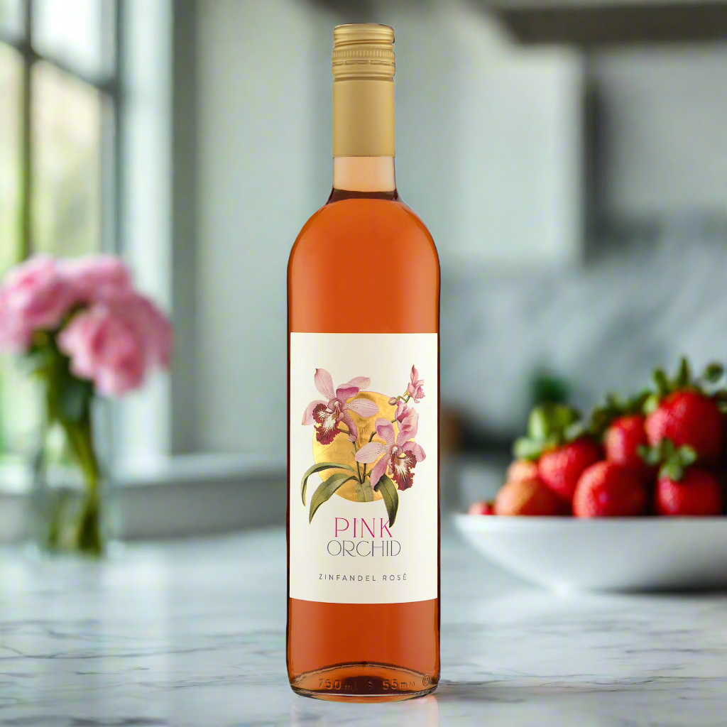 Bright modern kitchen with soft natural light, a bottle of rosé on a marble counter with two glasses, fresh flowers, and strawberries in a ceramic bowl