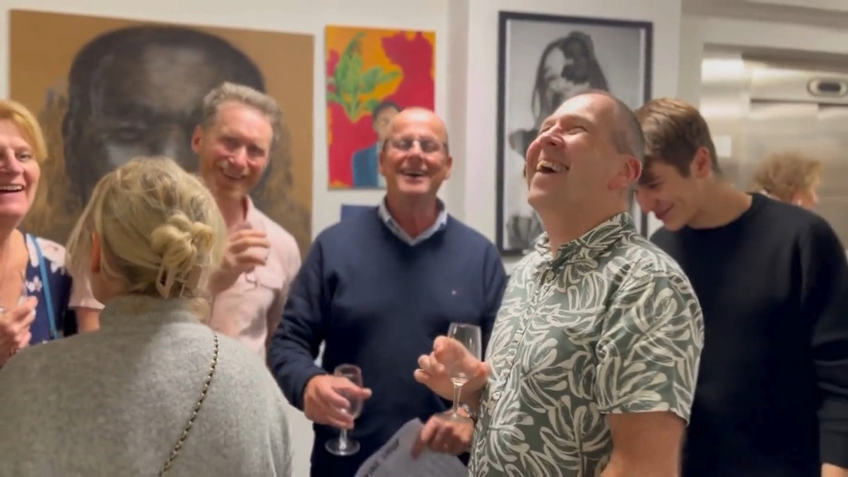 Guests laughing together with a glass of wine at the Somerset Wine Fair